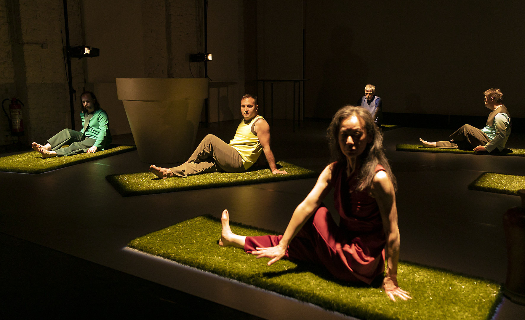 Scene photo of a performance: Five people are sitting on a stage.