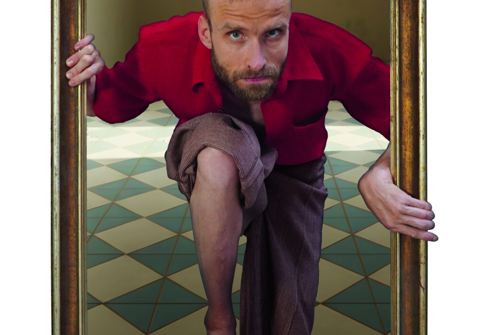 Ein Mann mit kurzem blondem Haar und rotem Hemd steigt scheinbar aus einem großen, aufrecht stehenden Bilderrahmen heraus. Er hat ein Knie nach vorne gesetzt und hält sich mit beiden Händen am Rahmen fest. Der Hintergrund zeigt einen geometrischen, gekachelten Boden. Die Szene wirkt wie eine optische Illusion, als würde der Mann aus dem Bild in den Raum treten.